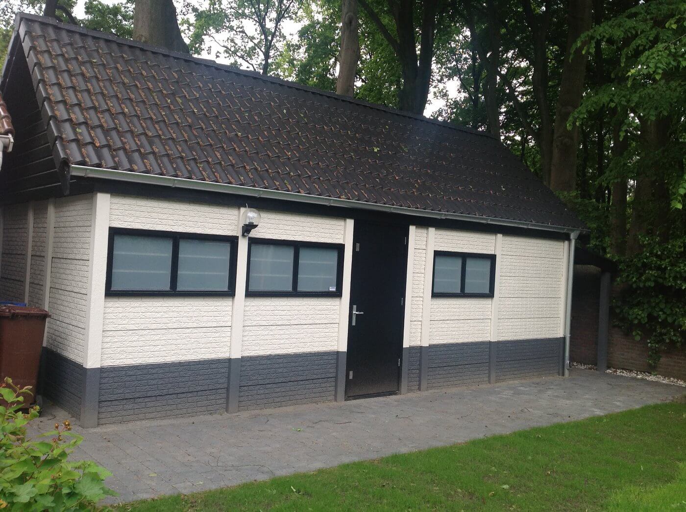 Prefab berging met een wit steenmotief.